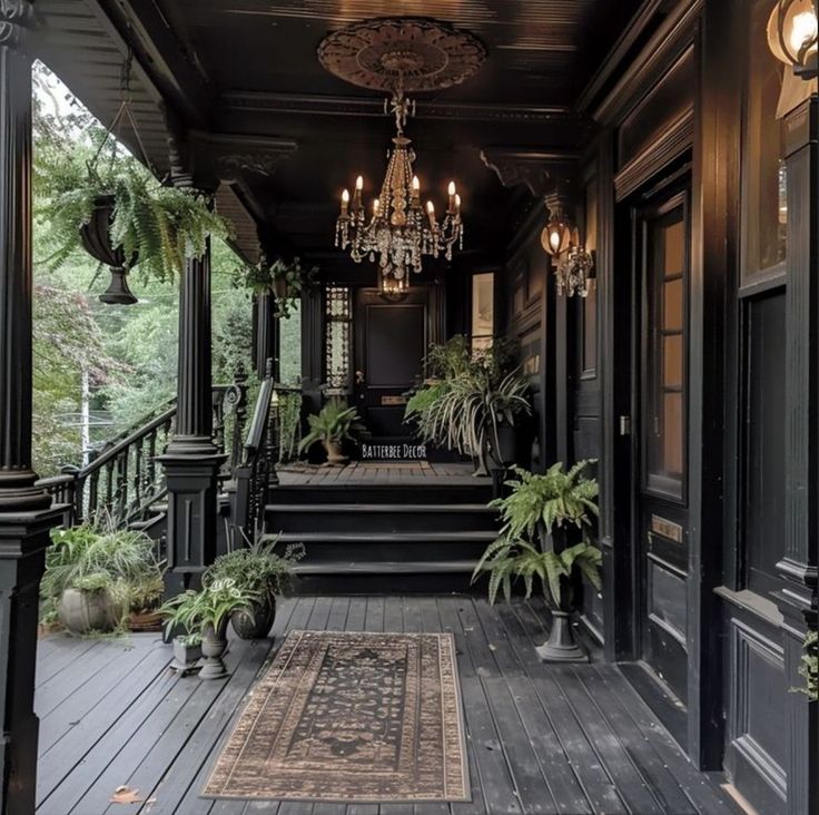 the front porch is decorated with plants and chandeliers on both sides of it