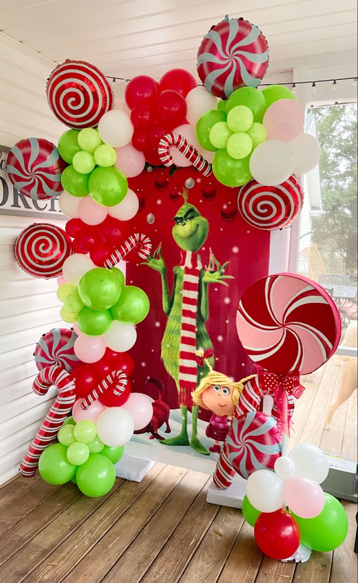 the grinch balloon arch is decorated with candy canes and balloons