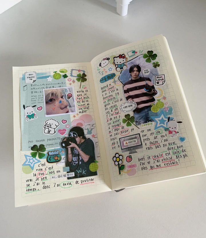 an open book with pictures and stickers on it