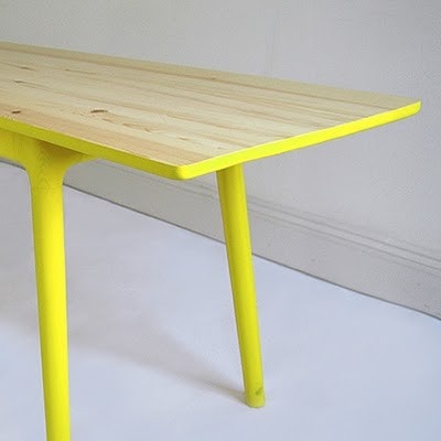 the table is made out of wood and has yellow legs