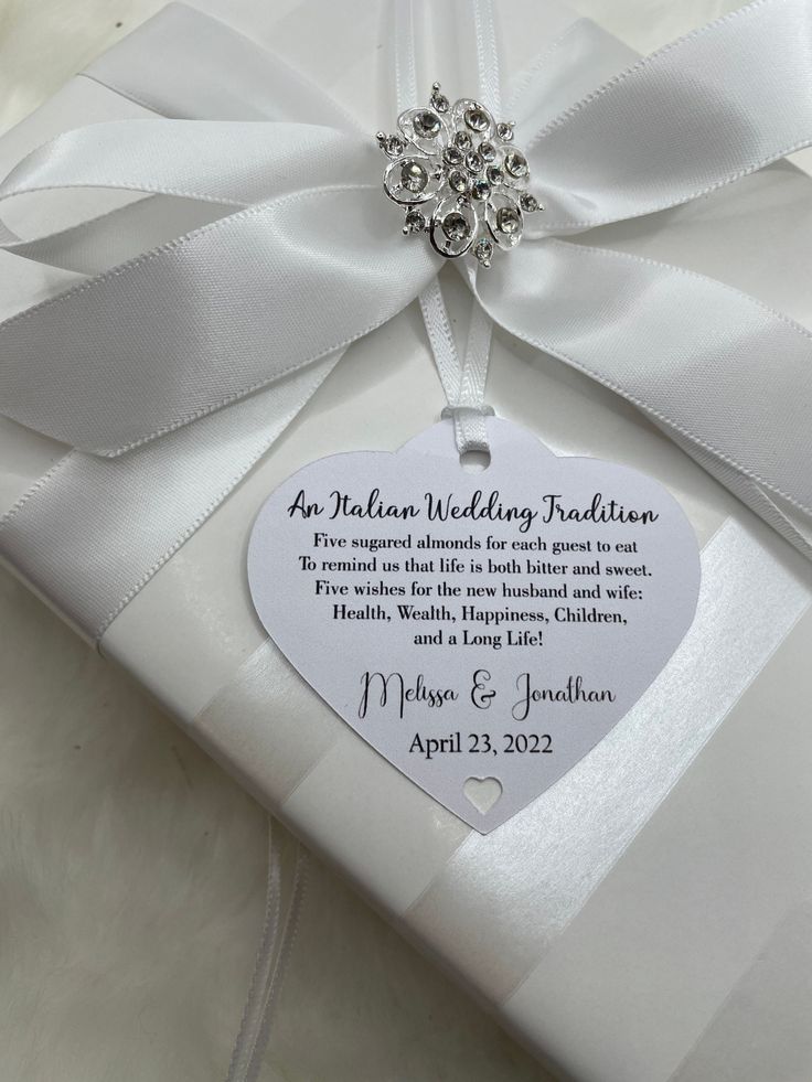 a white wedding gift wrapped in satin ribbon