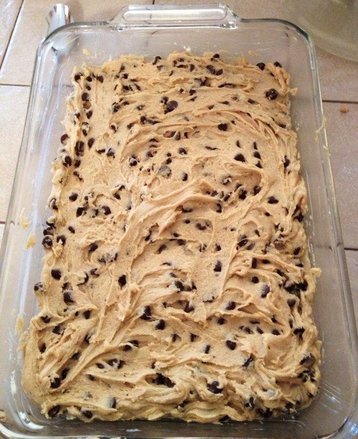 an uncooked cake with chocolate chips on top in a glass baking dish, ready to be baked