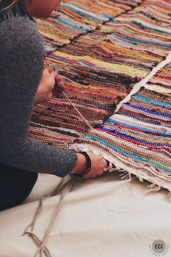 a woman is working on a weaving project