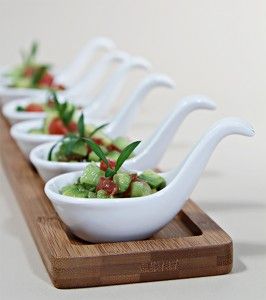 a row of white bowls filled with food