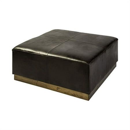 a black leather ottoman sitting on top of a wooden table