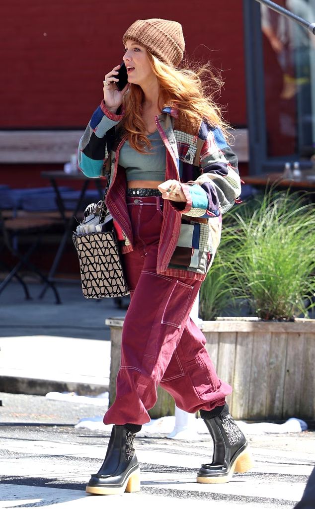 a woman walking across a street while talking on a cell phone