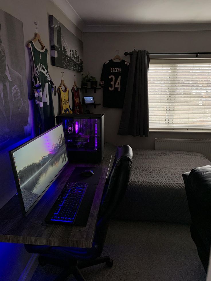 a bedroom with a bed, desk and laptop computer on it in front of a window