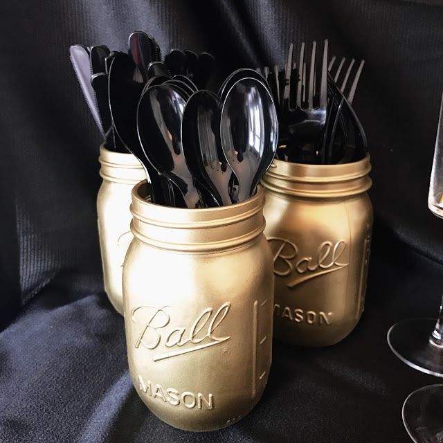 two mason jars with spoons and forks in them