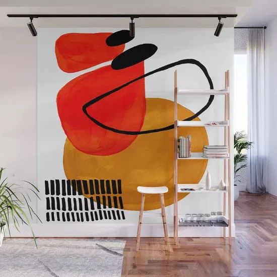 an abstract painting with orange and black colors on a white wall in a living room