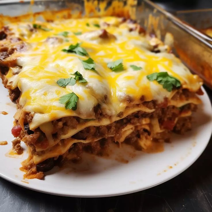 a white plate topped with lasagna covered in cheese