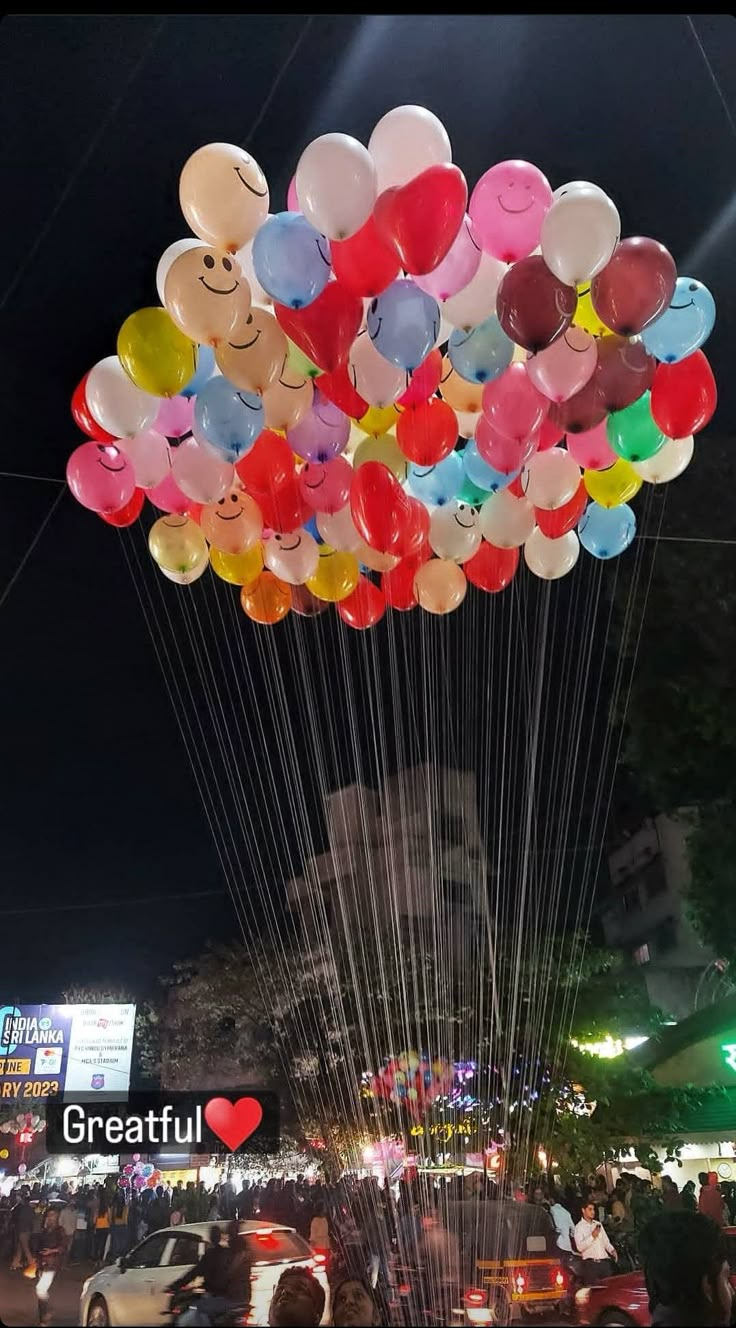 a bunch of balloons that are floating in the air