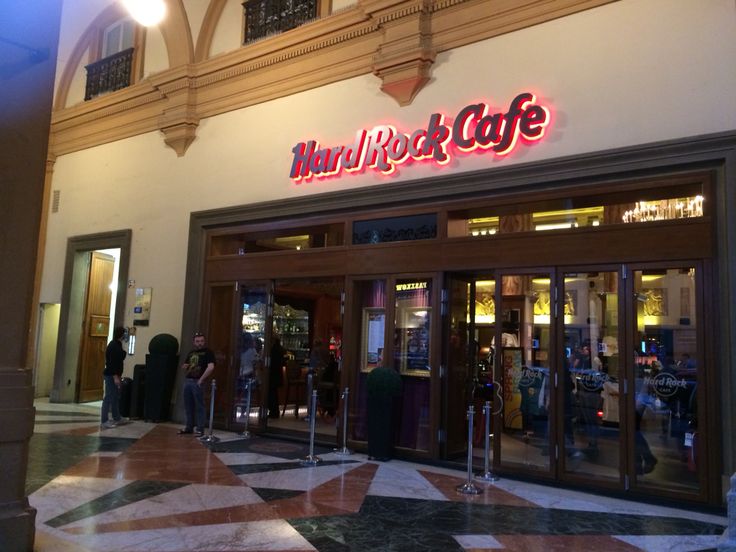 the entrance to a restaurant with people standing outside