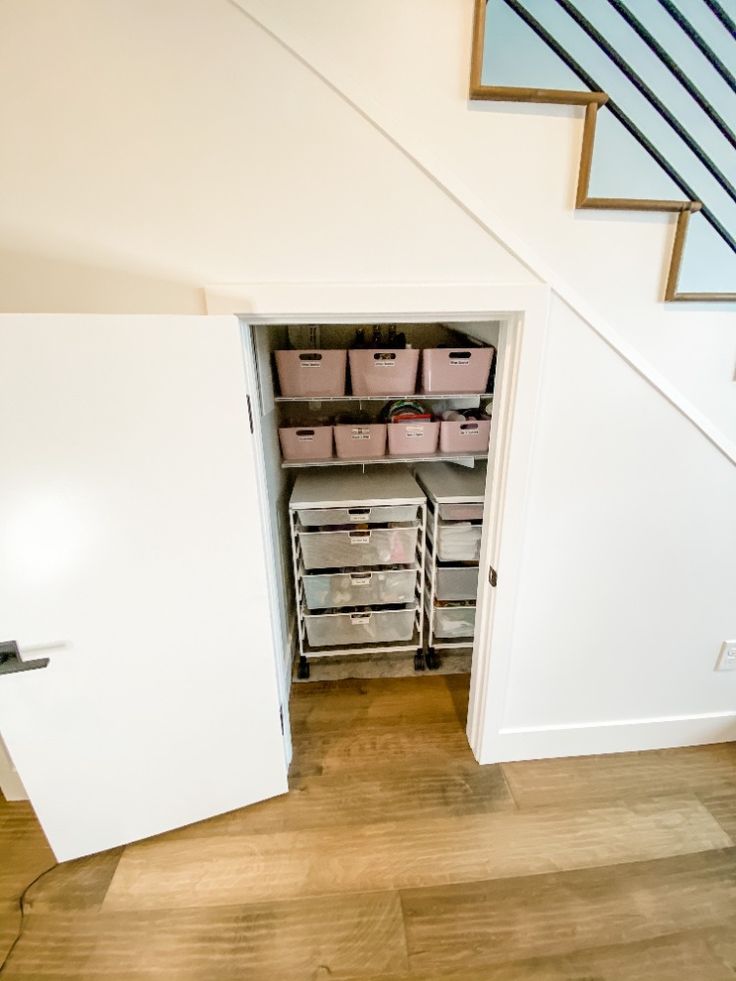 Stairwell storage closet organized with Elfa Start-A-Stack rolling drawer units and a couple of shelves Bathroom Under Staircase, Closet Tiny House, Under Stairs Library, Stairwell Storage, Tiny Closet Organization, Closet Under Stairs, Tiny Closet, Closet And Bathroom, Attic Stairs