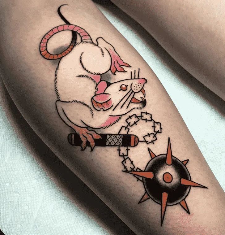 a person with a tattoo on their leg that has a mouse and compass on it