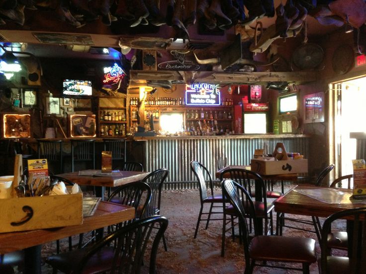 the inside of a restaurant with many tables and chairs