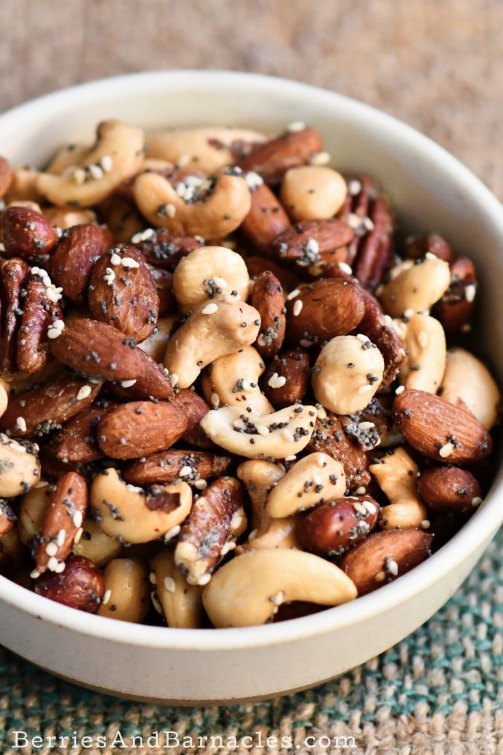 a white bowl filled with nuts on top of a table