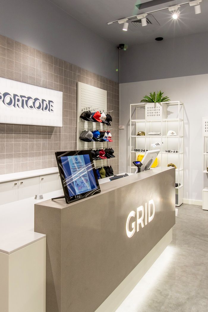 the front desk of a shoe store with a laptop on it's display shelf