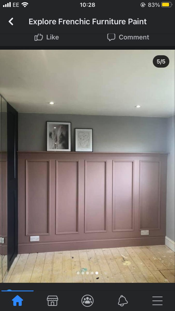 an empty room with wooden paneling and pictures on the wall in front of it