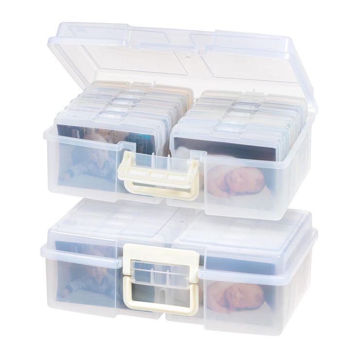 three plastic storage boxes with lids and handles on each side, one holding two babies