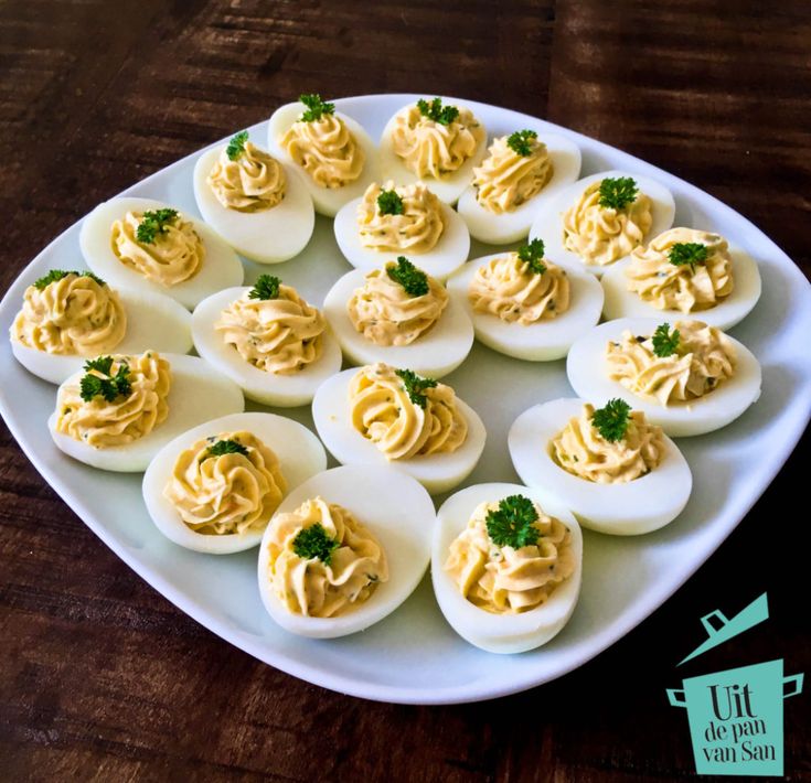 deviled eggs are arranged on a white plate