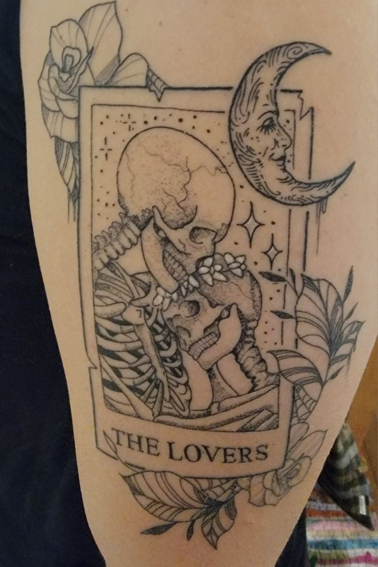 a tattoo with an image of a skeleton holding a cat on it's back