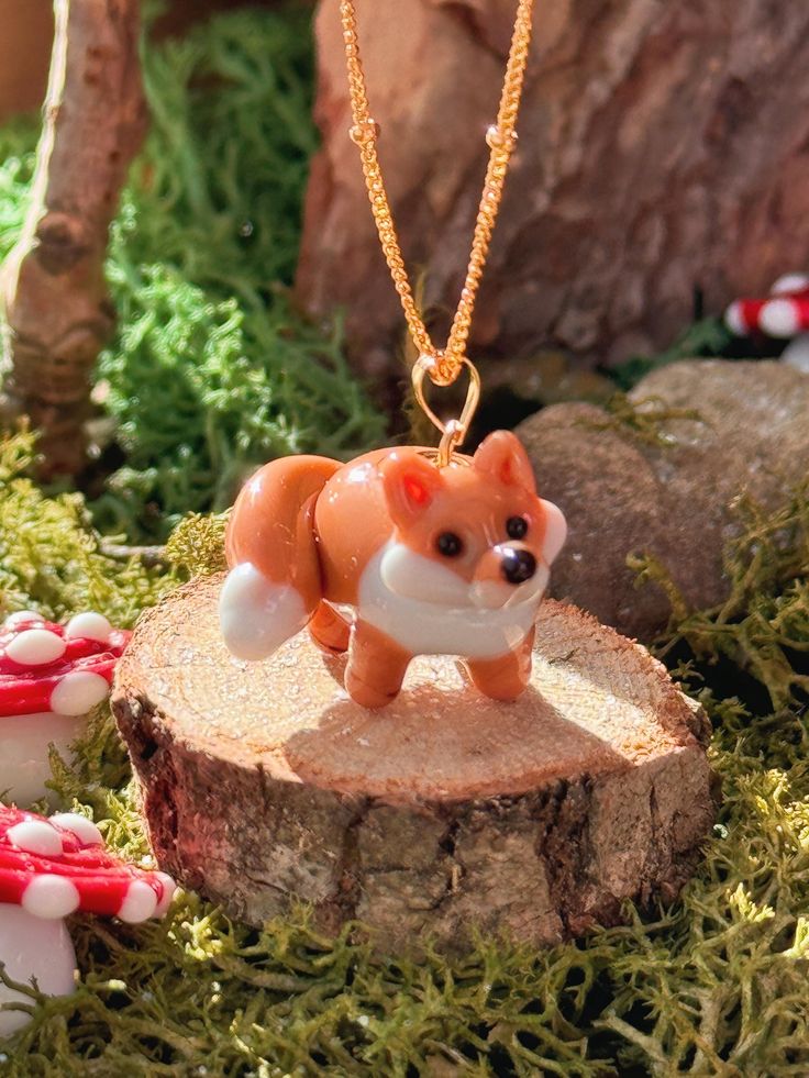 Introducing our brand new Fox charm necklace! A beautiful lampwork pendant necklace, finished in a classic style. This piece is perfect for wearing on its own or layered with our other necklaces. Every Picnic Blanket piece is lovingly designed and handcrafted completely in-house and perfectly finished in our jewellery studio.  The Lampwork Process Every individual glass feature charm takes around half an hour to delicately form by hand in the flame, reaching temperatures of up to 800 degrees celsius, before heading to the kiln to soak for around 8 hours in the warmth to ensure strength and longevity. The charms are then washed by hand to release them from the mandrel, cleaned, reamed and polished, before making their way to our finishing table, ready to be made into something dreamy. With Fox Charm, Jewellery Studio, Lampwork Pendant, Jewelry Studio, The Flame, Delicate Jewelry, Gift Stickers, Necklace Handmade, Lampwork Beads