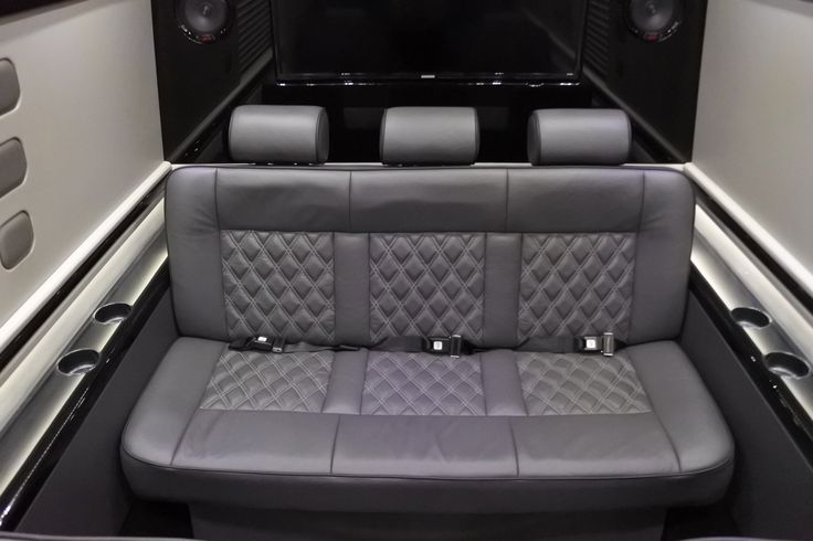 the inside of an airplane with two seats and speakers on each side of the seat