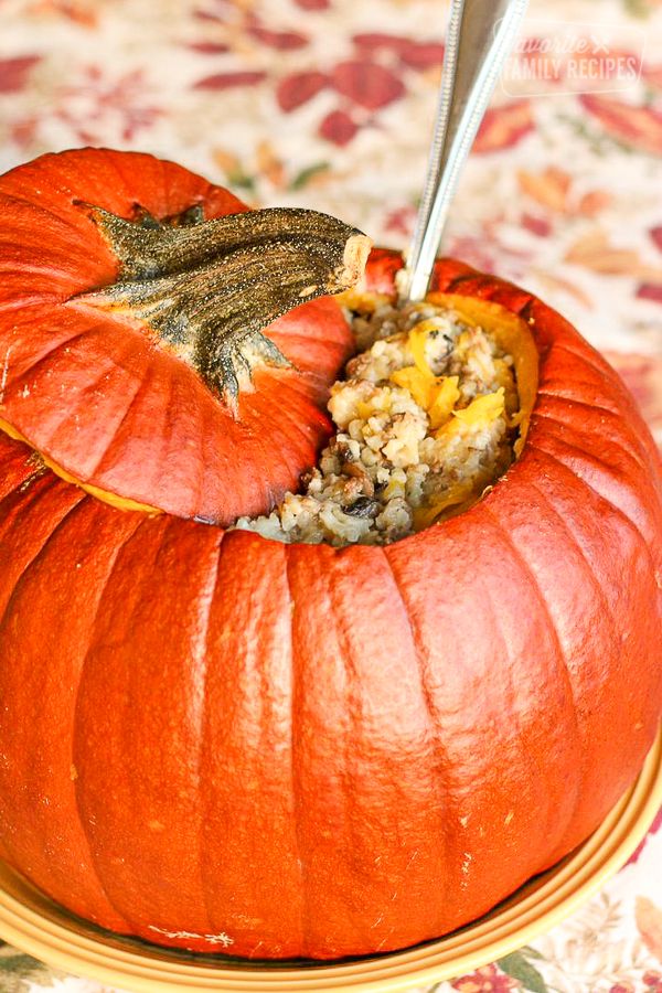 there is a stuffed pumpkin that has been cut in half with a fork inside it