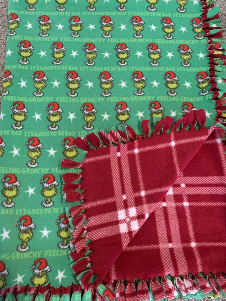 two green christmas wrappings with red and white plaid on them, one has an elf hat