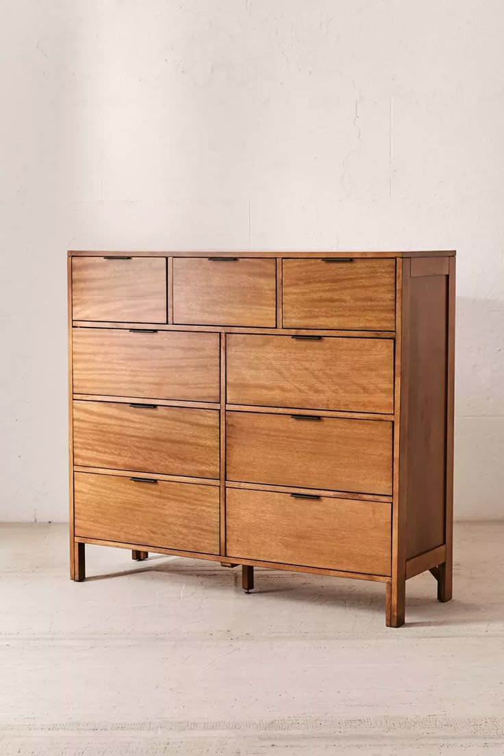 a large wooden dresser sitting on top of a white floor