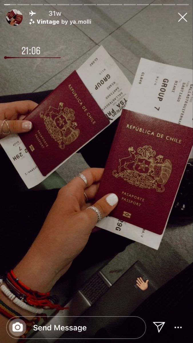 two people are holding their passports in their hands