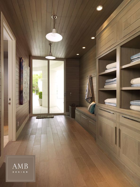 a large room with wooden floors and shelves filled with folded towels on top of them