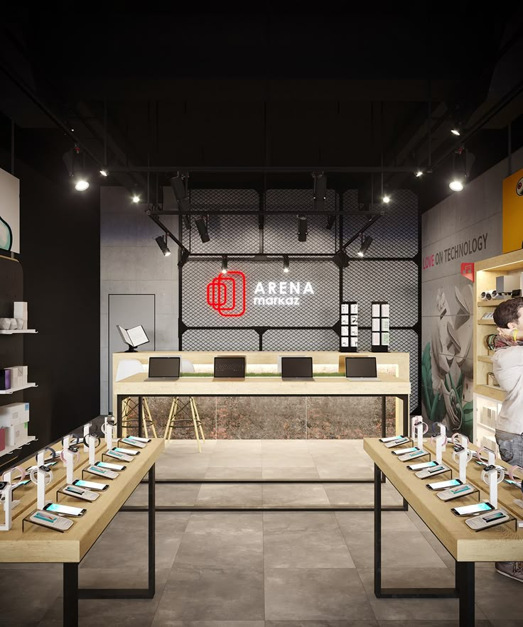 the interior of an electronics store with several tables and laptops on display in front of them