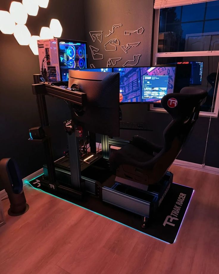 a computer desk with two monitors and a keyboard on it in front of a window