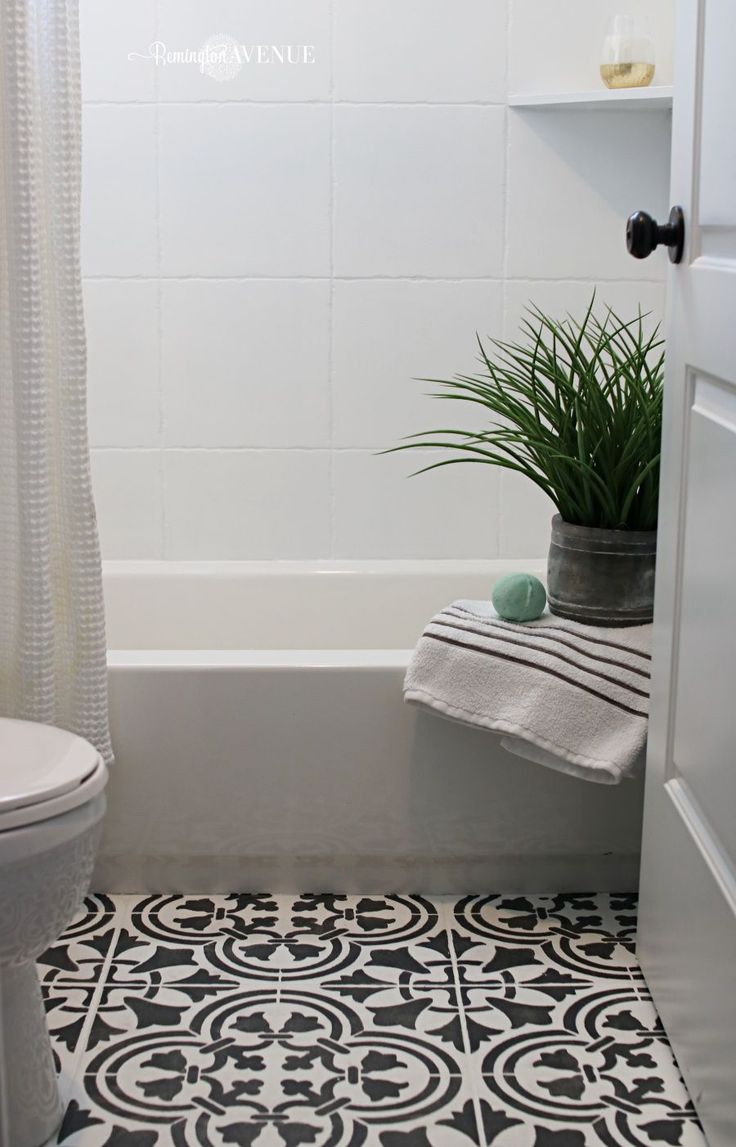 a white toilet sitting next to a bath tub