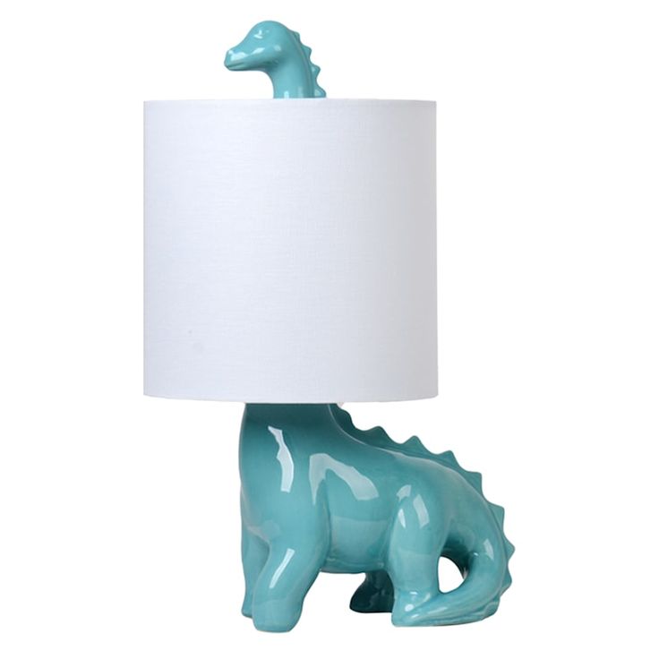 a blue ceramic dinosaur lamp with a white shade on it's head and neck