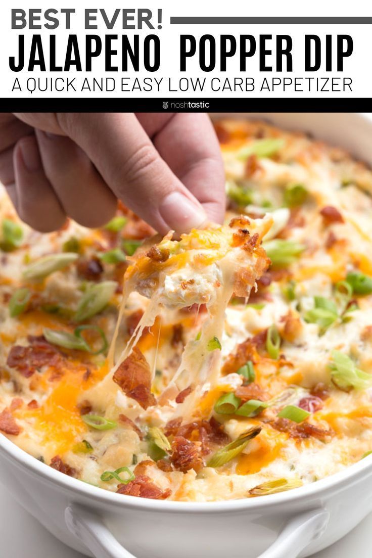 a person scooping some food out of a white casserole dish with cheese and green onions