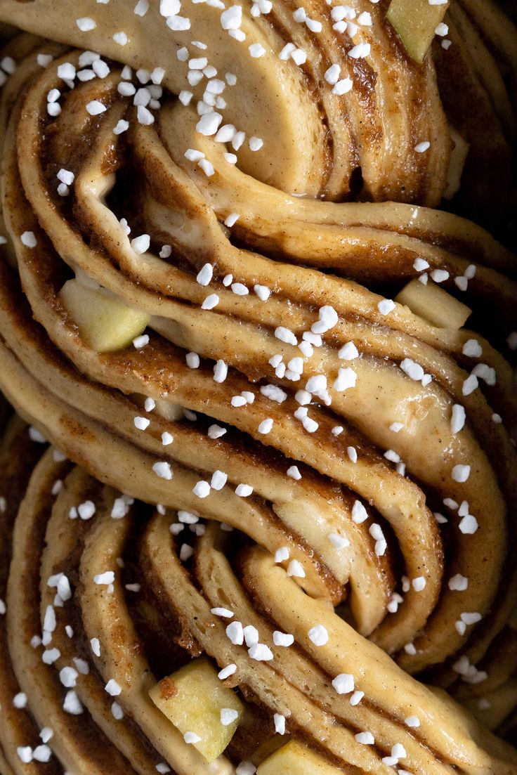 a pile of food that is sitting on top of a plate with white sprinkles