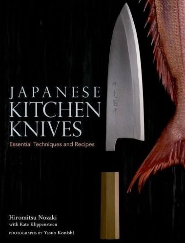 an advertisement for japanese kitchen knives with a fish on it's head and knife in the background