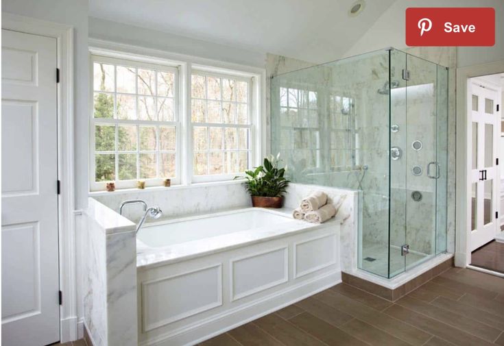 a bathroom with a tub, sink and shower