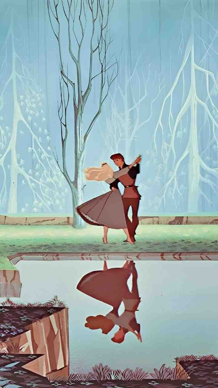 two people are dancing in front of a pond with trees and snow on the ground