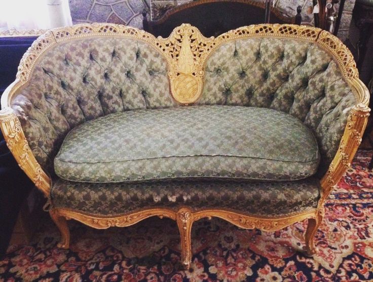 an ornate couch sitting on top of a rug