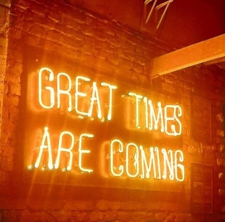 a neon sign that says great times are coming