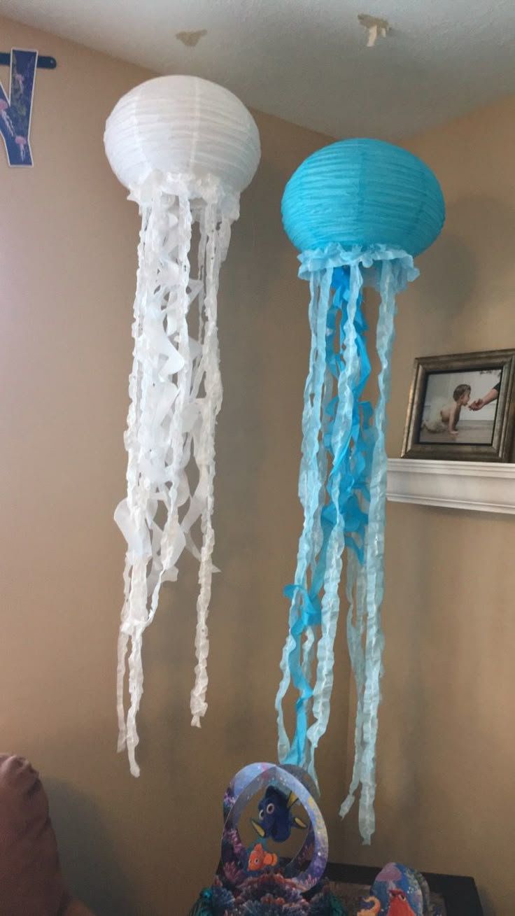 two jellyfish decorations hanging from the ceiling