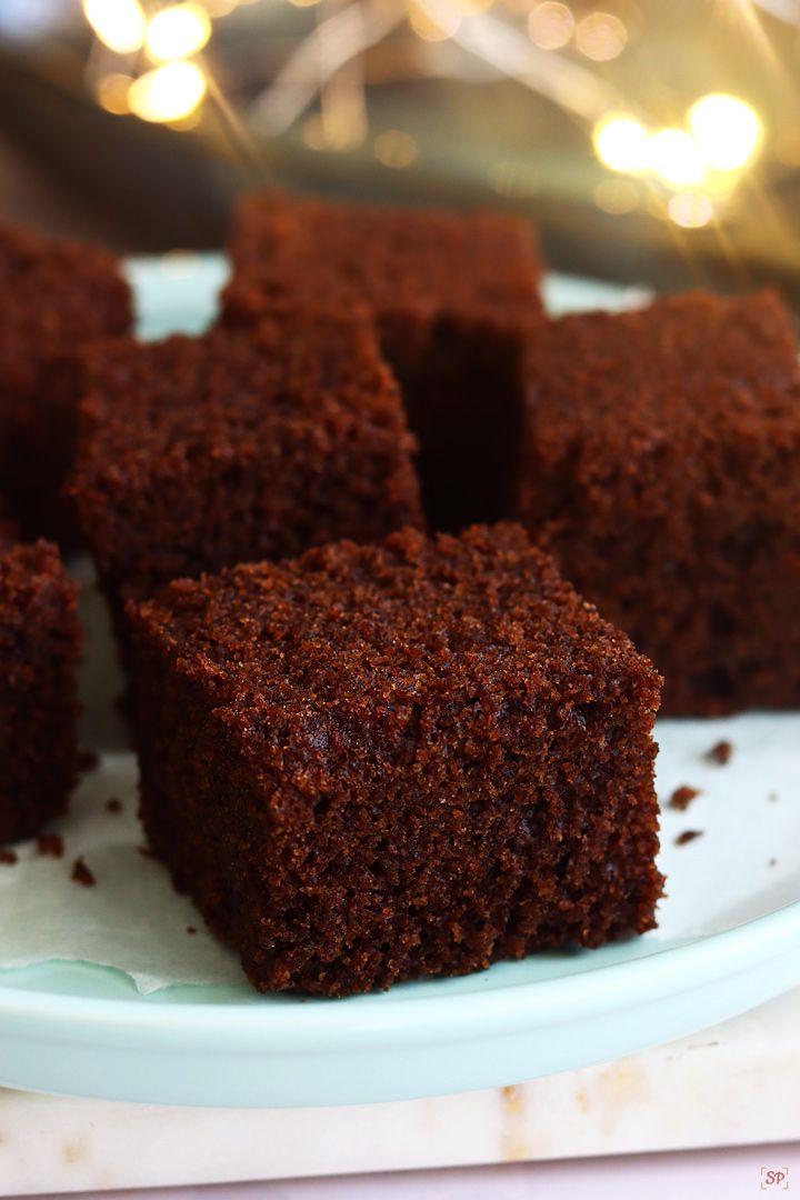 several pieces of brownie on a plate with christmas lights in the backgroud