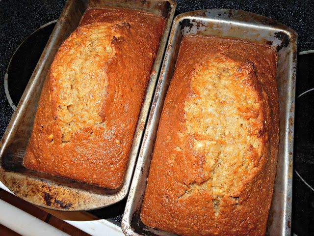 two pans filled with baked food sitting on top of a stove next to each other