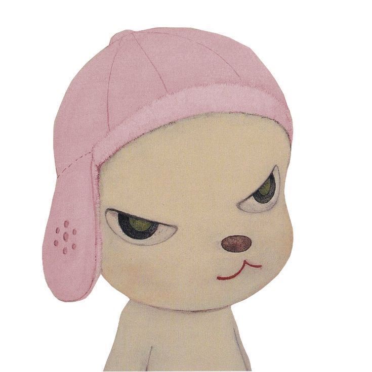 a small stuffed animal with a pink hat on it's head and green eyes