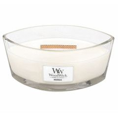 a white candle in a glass bowl with a label on the front and side of it