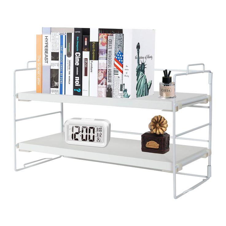 a white shelf with books and alarm clocks