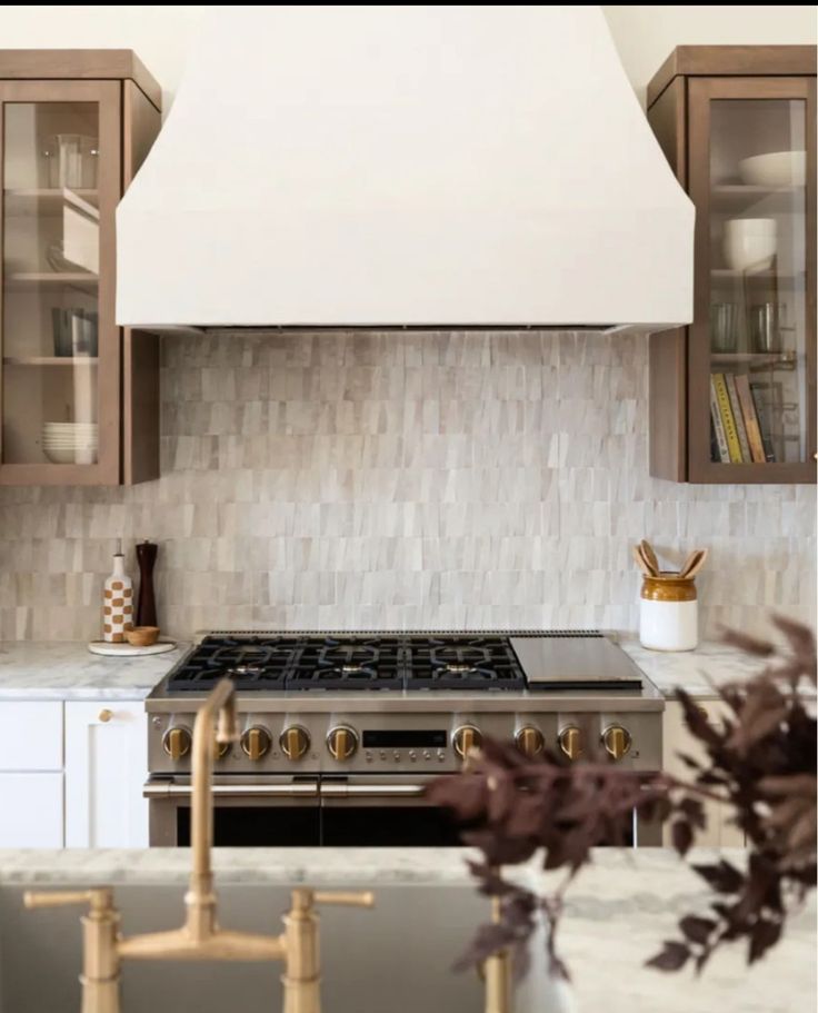 a stove top oven sitting inside of a kitchen next to wooden cabinets and counter tops